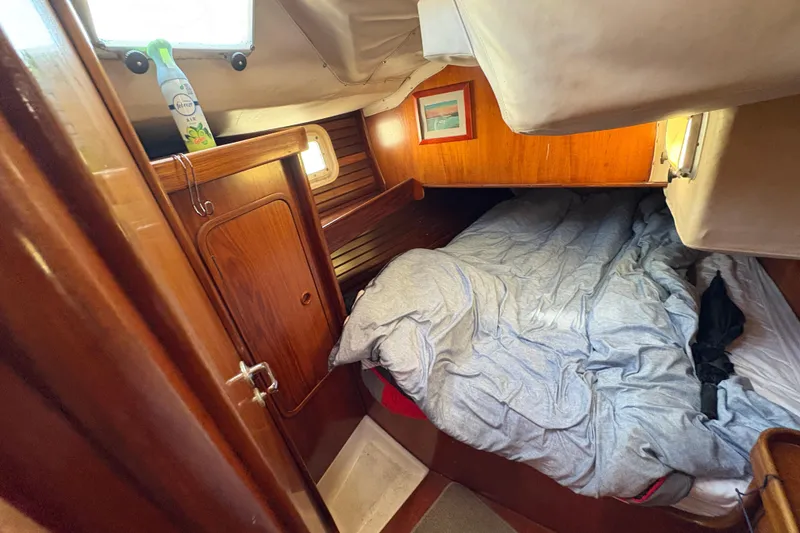 Slide: The Image of Cozy cabin interior of 1990 Beneteau Oceanis 500 sailboat with wooden finish and bed. - 83