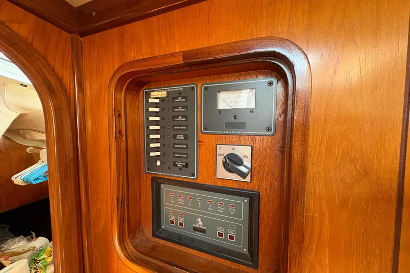 Slide: The Image of Control panel on 1990 Beneteau Oceanis 500 yacht, featuring switches and gauges. - 88