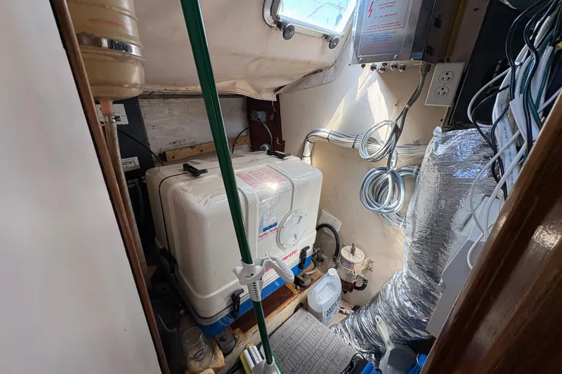 Slide: The Image of Engine room of 1990 Beneteau Oceanis 500 sailboat, featuring generator and wiring. - 91