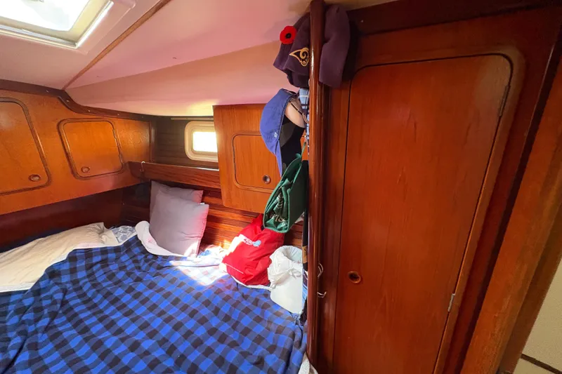 Slide: The Image of Cozy cabin interior of 1990 Beneteau Oceanis 500 sailboat with wooden finish and bedding. - 96