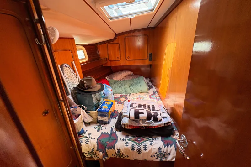 Slide: The Image of Cozy cabin interior of 1990 Beneteau Oceanis 500 sailboat with wooden paneling and bedding. - 98