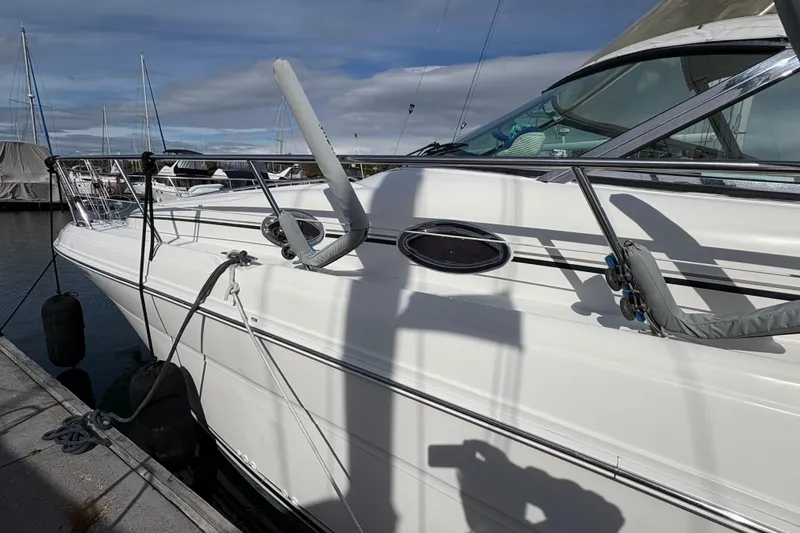 Slide: The Image of 2003 Sea Ray 360 Sundancer yacht docked at marina under cloudy sky. - 12