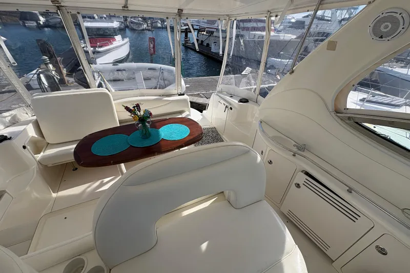 Slide: The Image of Interior of 2003 Sea Ray 360 Sundancer yacht with elegant seating and table setup. - 20