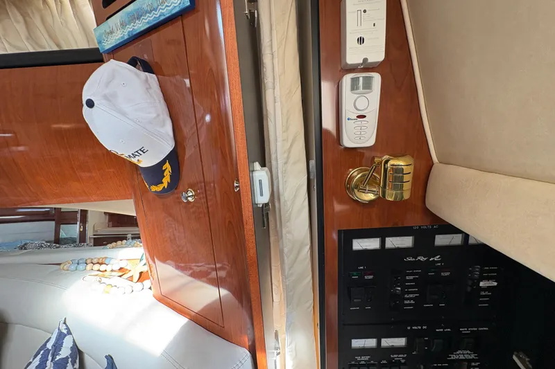 Slide: The Image of Interior of 2003 Sea Ray 360 Sundancer with control panel and wooden cabinetry. - 35