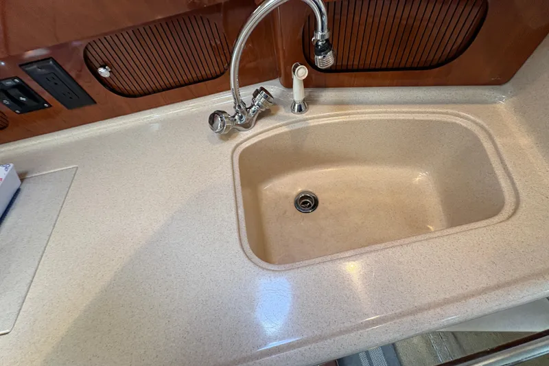 Slide: The Image of Kitchen sink area on a 2003 Sea Ray 360 Sundancer yacht. - 44