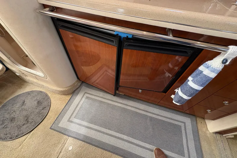 Slide: The Image of 2003 Sea Ray 360 Sundancer interior with wood cabinetry and carpeted flooring. - 45