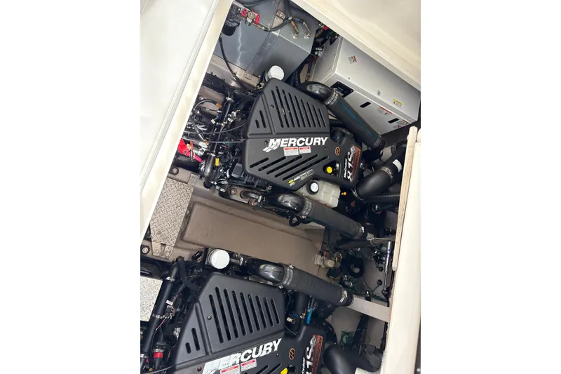 Slide: The Image of Engine compartment of a 2003 Sea Ray 360 Sundancer with Mercury engines. - 53