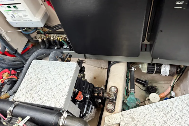 Slide: The Image of Engine compartment of a 2003 Sea Ray 360 Sundancer boat, showing mechanical components. - 60