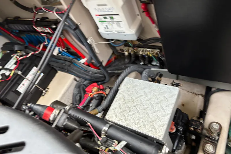 Slide: The Image of Engine compartment of a 2003 Sea Ray 360 Sundancer with visible wiring and components. - 61