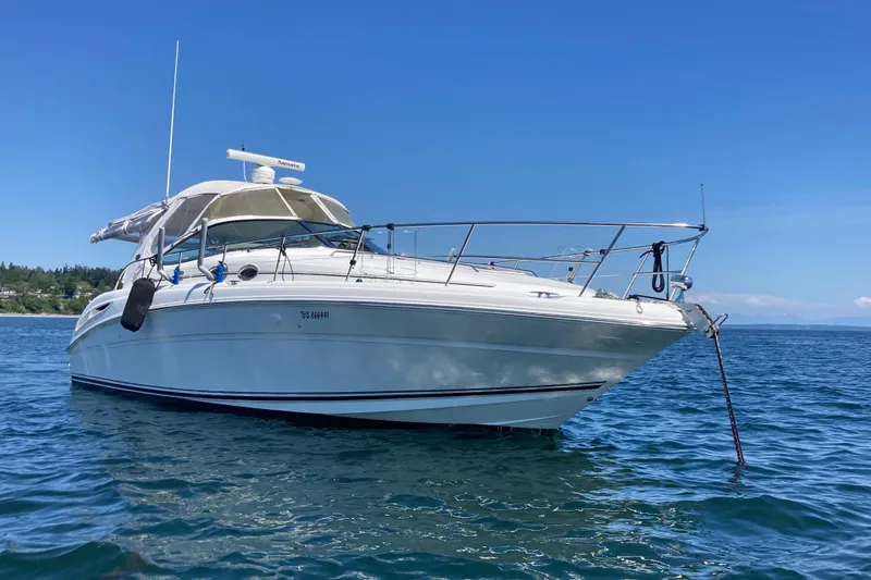 Slide: The Image of 2003 Sea Ray 360 Sundancer yacht anchored on calm blue water under clear sky. - 66