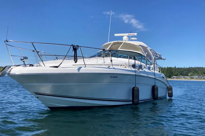 Slide: The Image of 2003 Sea Ray 360 Sundancer yacht on calm water under clear blue sky. - 68
