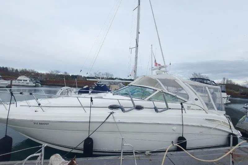 Slide: The Image of 2003 Sea Ray 360 Sundancer yacht docked in a marina, overcast sky. - 7