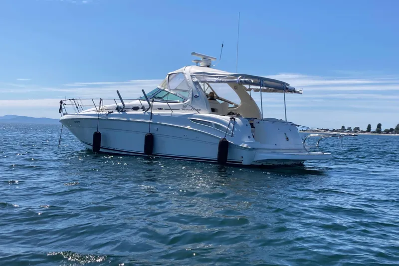 Slide: The Image of 2003 Sea Ray 360 Sundancer yacht on calm blue waters under clear sky. - 70