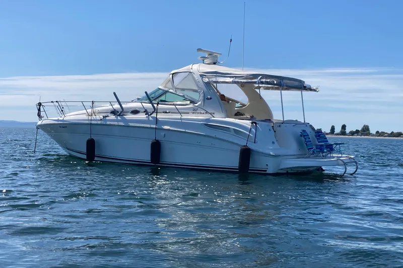 Slide: The Image of 2003 Sea Ray 360 Sundancer yacht on calm water under clear blue sky. - 72