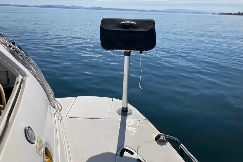 Slide: The Image of 2003 Sea Ray 360 Sundancer boat with Magma grill on calm water. - 74