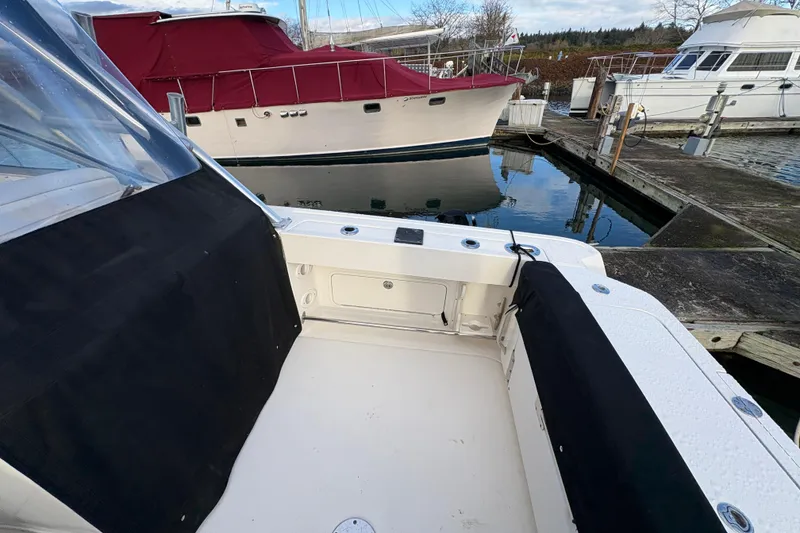 Slide: The Image of 2009 Sea Ray 290 Amberjack boat docked at marina, featuring spacious deck area. - 32