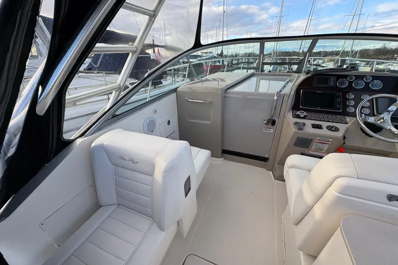 Slide: The Image of 2009 Sea Ray 290 Amberjack boat interior with helm and seating area. - 39