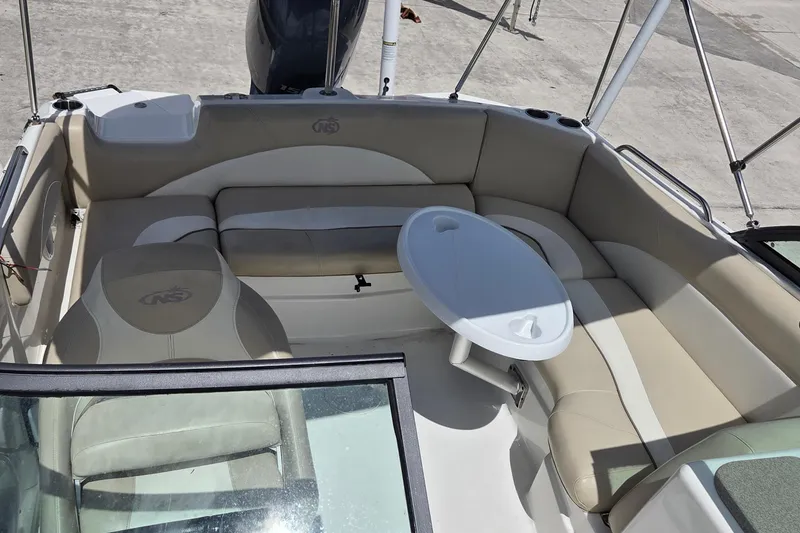 Slide: The Image of 2017 NauticStar 203DC Sport Deck interior with seating and table. - 10