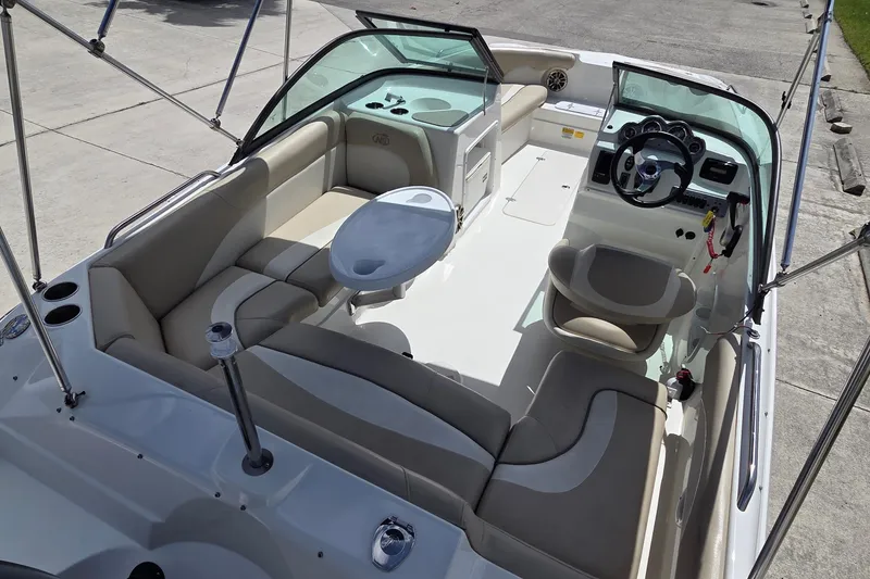 Slide: The Image of 2017 NauticStar 203DC Sport Deck boat interior with seating and steering console. - 11