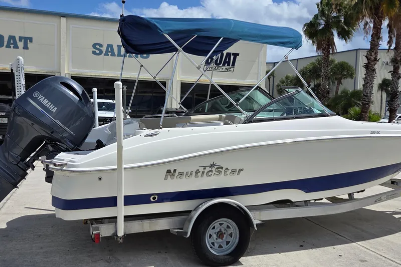 Slide: The Image of 2017 NauticStar 203DC Sport Deck boat with Yamaha engine, parked outside dealership. - 12