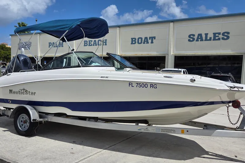 Slide: The Image of 2017 NauticStar 203DC Sport Deck boat on trailer at Palm Beach Boat Sales. - 13