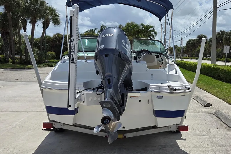 Slide: The Image of 2017 NauticStar 203DC Sport Deck boat with Yamaha outboard motor, parked on trailer. - 14