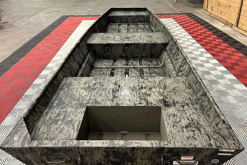 Slide: The Image of 2026 Tracker Grizzly 15 Jon boat with camouflage design on checkered flooring. - 2