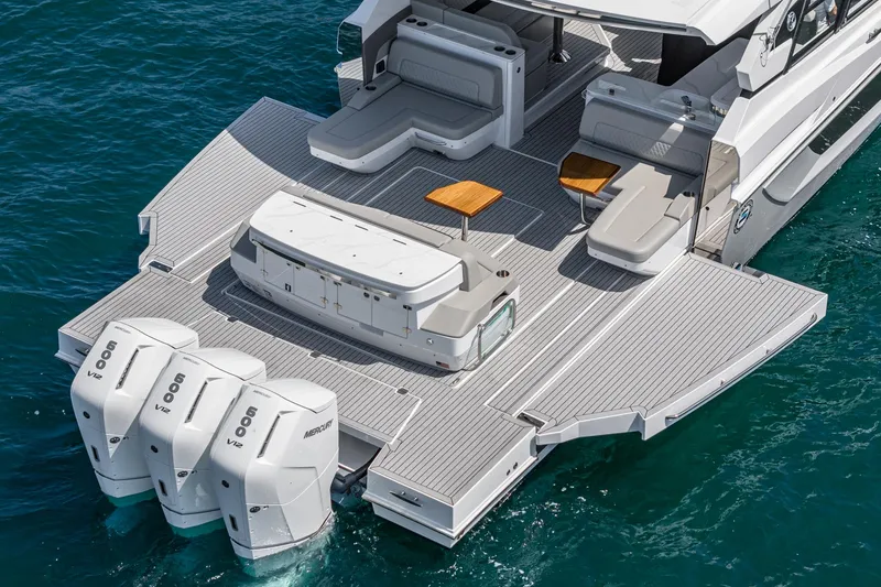 Slide: The Image of 2024 Cruisers Yachts 50 GLS with spacious deck and triple outboard engines. - 13