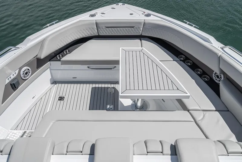 Slide: The Image of 2024 Cruisers Yachts 50 GLS bow seating area with table and speakers. - 19