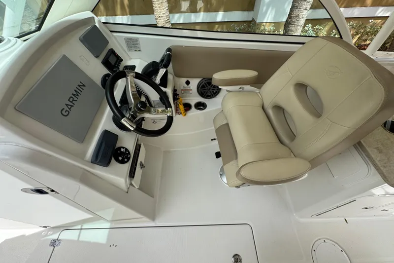 Slide: The Image of 2018 Sailfish 275 DC boat interior with beige seating and foldable bench. - 13