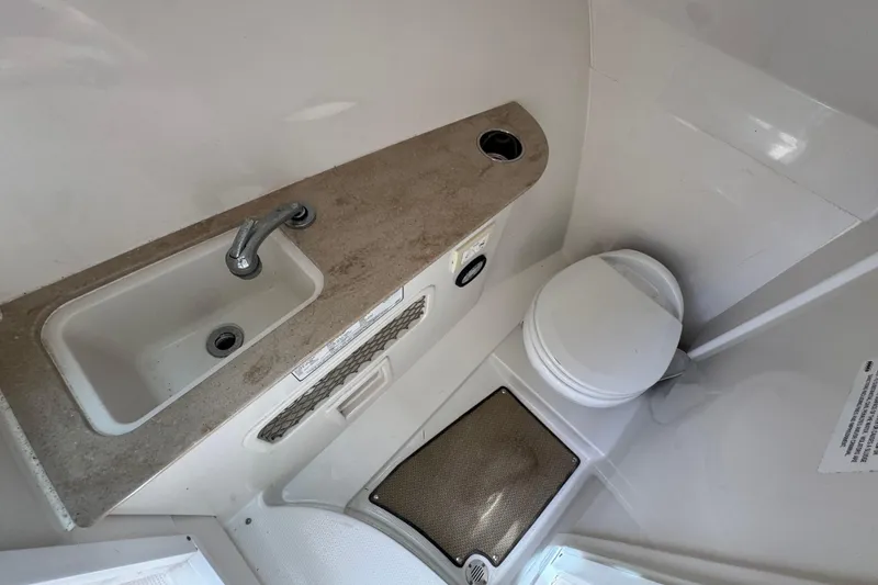 Slide: The Image of Interior of 2018 Sailfish 275 DC boat with helm, sink, and storage compartments. - 21