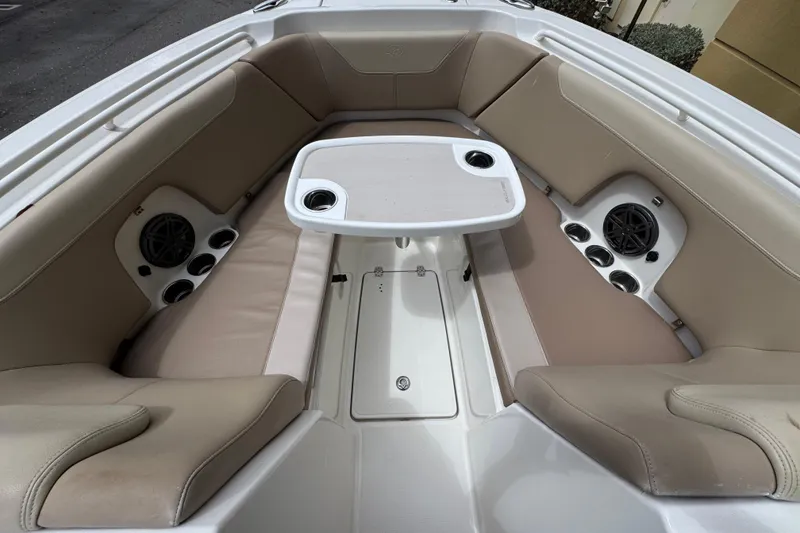 Slide: The Image of Interior of 2018 Sailfish 275 DC boat with beige seating and table. - 24
