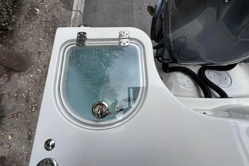 Slide: The Image of 2018 Sailfish 275 DC boat interior with clear panels and dual engines. - 26