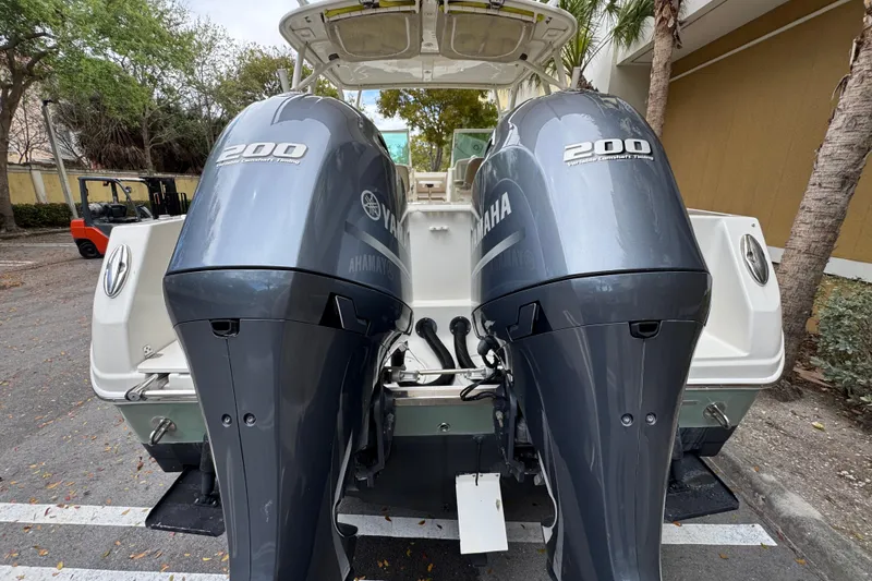 Slide: The Image of 2018 Sailfish 275 DC boat with dual Yamaha 200 engines, parked outdoors. - 4