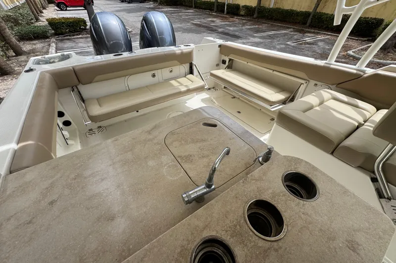 Slide: The Image of 2018 Sailfish 275 DC boat interior with seating and dual outboard motors. - 8