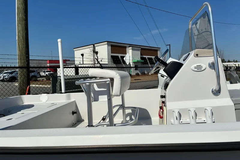 Slide: The Image of 2024 ALK2 Powerboats 21BHX interior with steering console and seating, outdoor setting. - 3