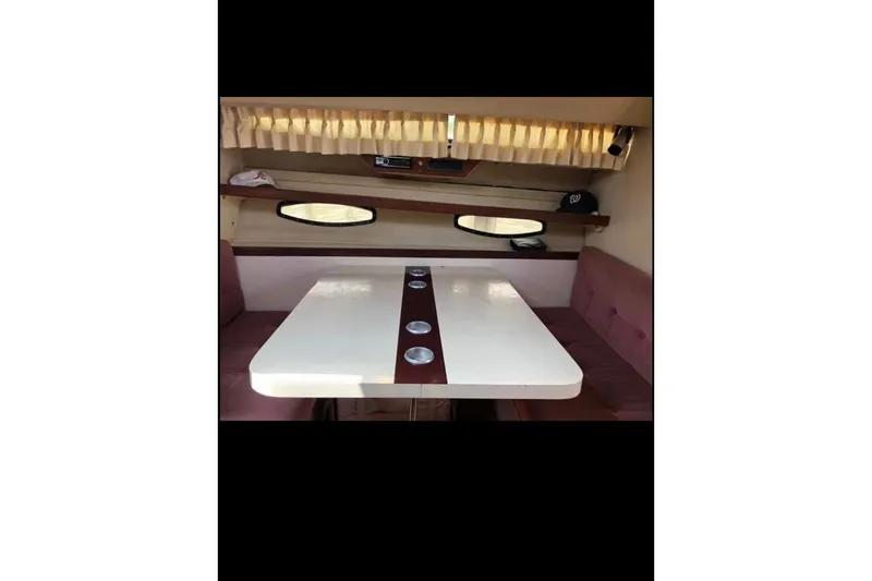 Slide: The Image of Interior of 1986 Wellcraft 3200 St. Tropez boat with dining table and seating. - 12