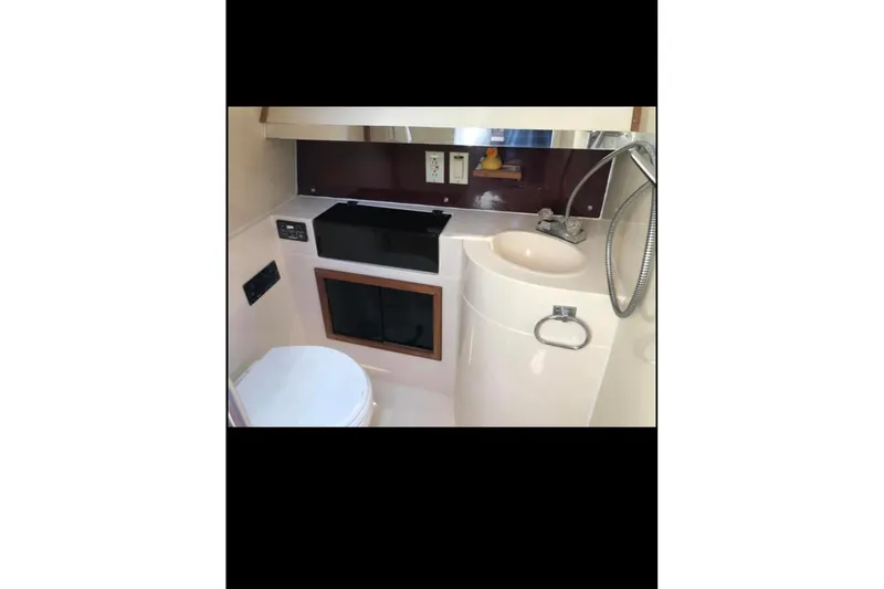 Slide: The Image of Interior of 1986 Wellcraft 3200 St. Tropez boat bathroom with sink and toilet. - 13
