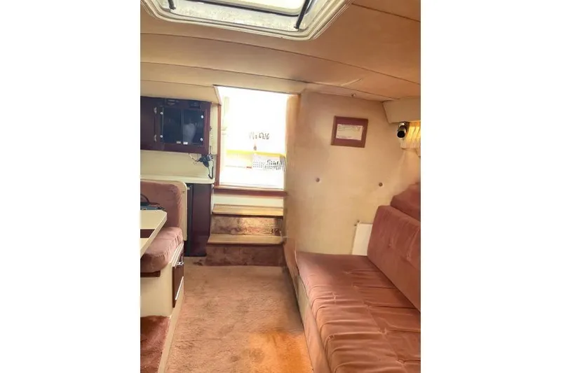 Slide: The Image of Interior of 1986 Wellcraft 3200 St. Tropez boat with plush seating and carpeted flooring. - 14
