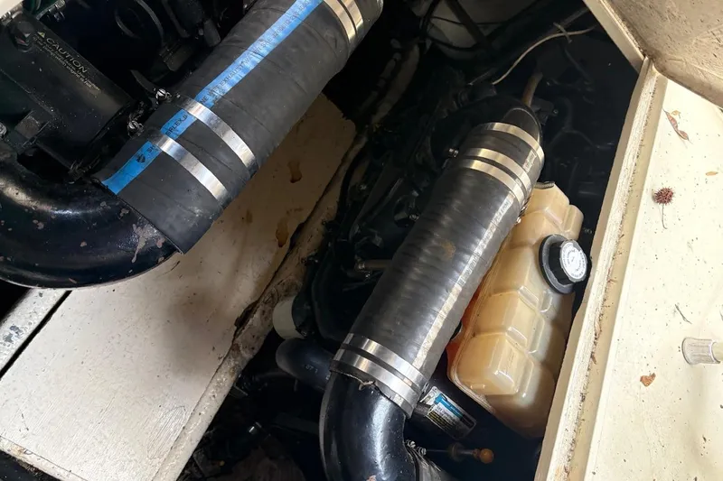 Slide: The Image of Engine compartment of a 1986 Wellcraft 3200 St. Tropez boat, showing hoses and fluid reservoir. - 5