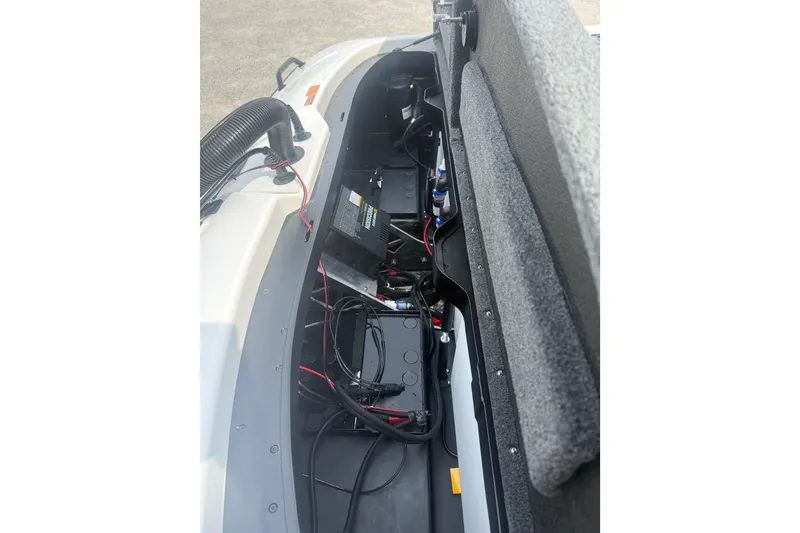 Slide: The Image of 2026 Skeeter ZXR21 SE boat battery compartment with wiring and components. - 10