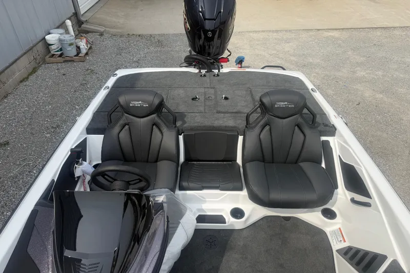 Slide: The Image of 2026 Skeeter ZXR21 SE boat interior with dual black seats and steering console. - 14