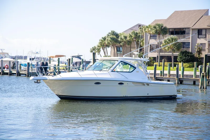 The Image of 2007 Tiara Yachts 3000 Open docked near waterfront homes and palm trees. - 1