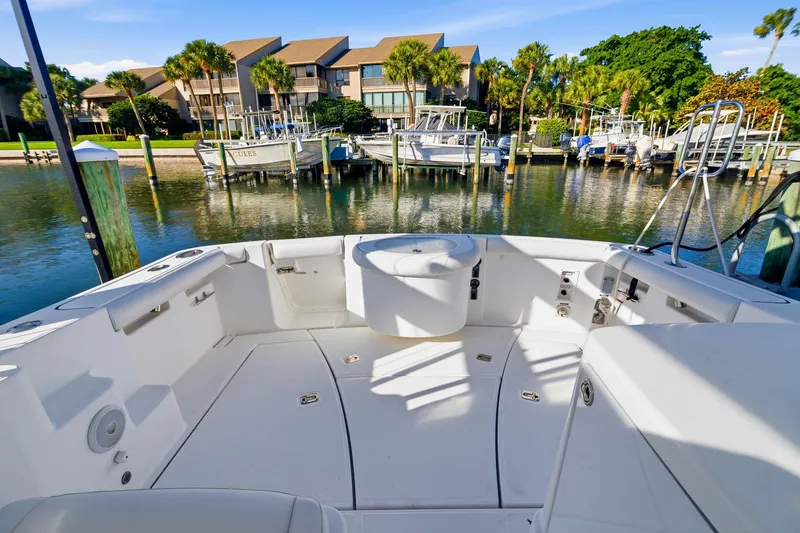 Slide: The Image of 2007 Tiara Yachts 3000 Open at marina, showcasing spacious deck and scenic waterfront view. - 11