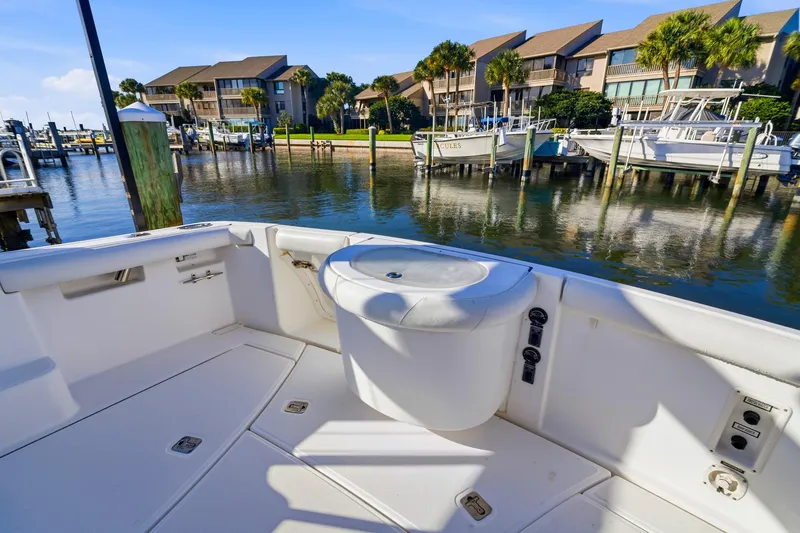 Slide: The Image of 2007 Tiara Yachts 3000 Open boat docked in a scenic marina setting. - 13