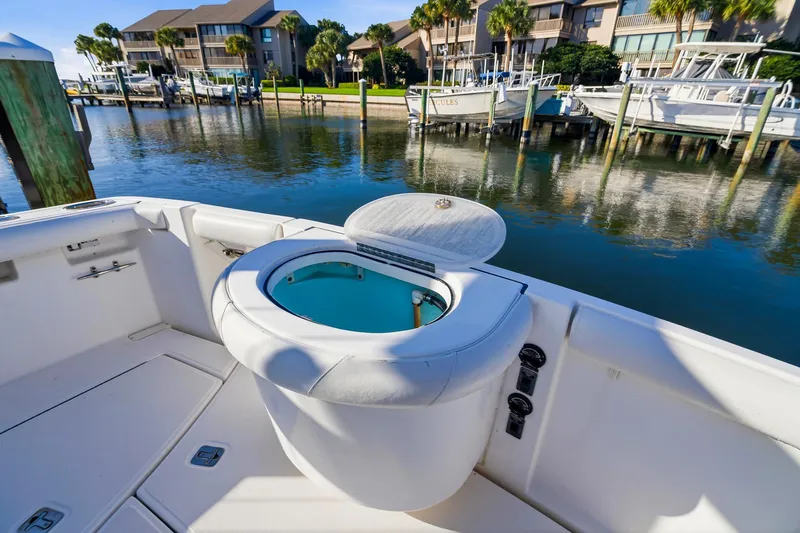 Slide: The Image of 2007 Tiara Yachts 3000 Open with livewell, docked in a scenic marina setting. - 14