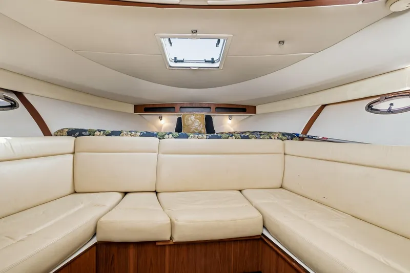 Slide: The Image of Interior of 2007 Tiara Yachts 3000 Open with beige seating and floral bedding. - 17