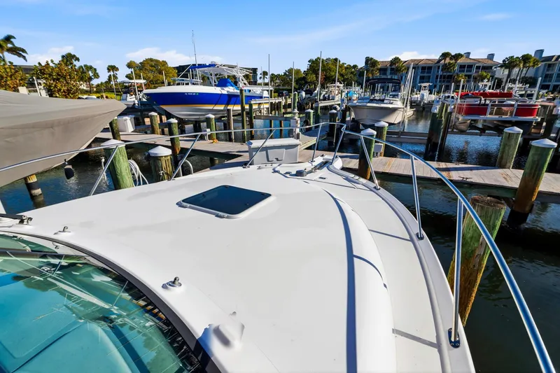 Slide: The Image of 2007 Tiara Yachts 3000 Open docked at a marina with other boats. - 19