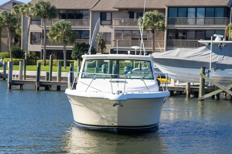 Slide: The Image of 2007 Tiara Yachts 3000 Open docked near waterfront homes. - 3