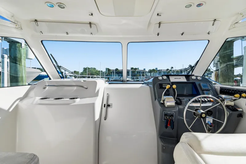 Slide: The Image of 2007 Tiara Yachts 3000 Open helm with steering wheel and control panel. - 5
